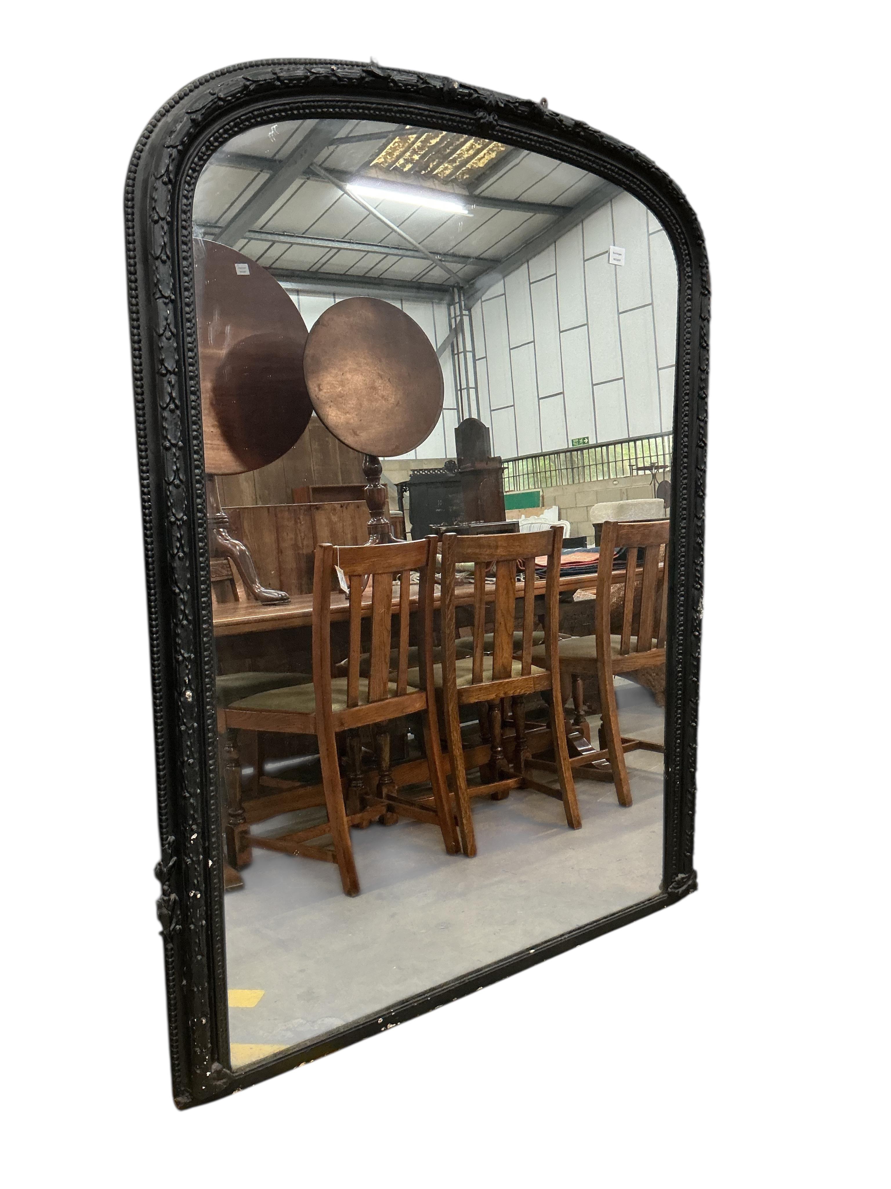 A Victorian overmantel mirror, later painted black, width 122cm, height 165cm